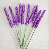 Crocheted lavender flowers, close-up view of 9c87ea6d...ffe87cbc