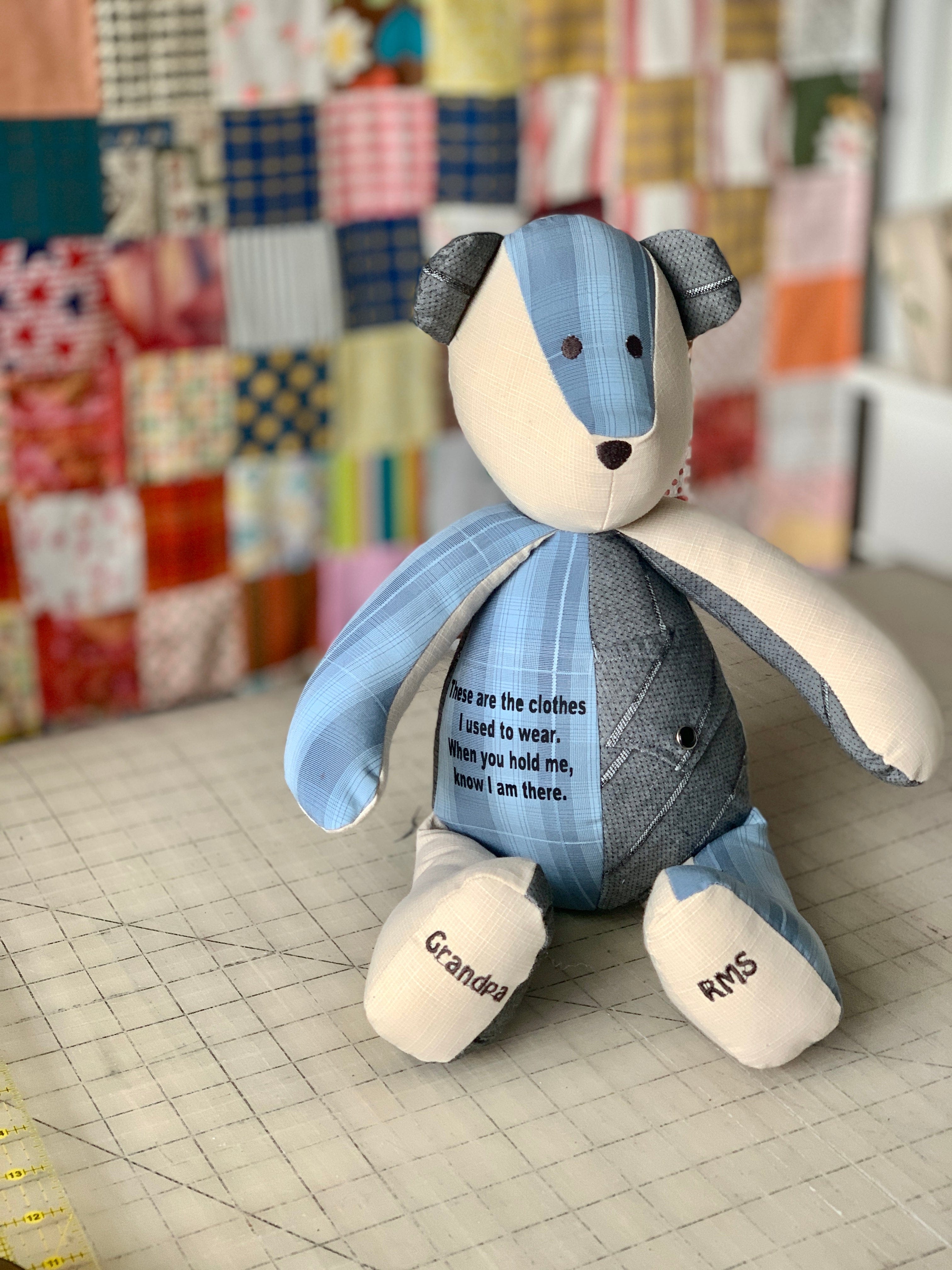 Blue and cream teddy bear with text on its body.