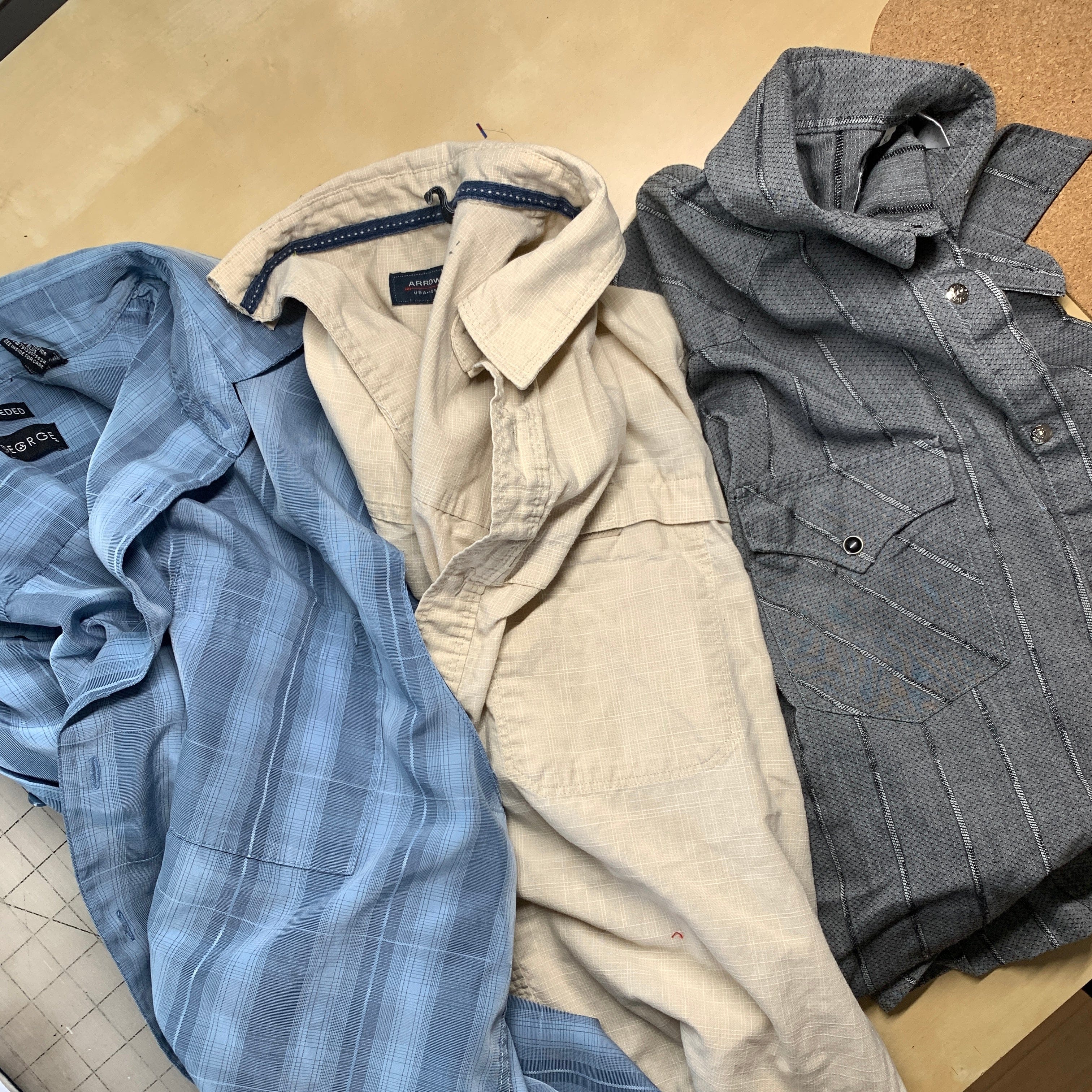 Three folded button-down shirts.