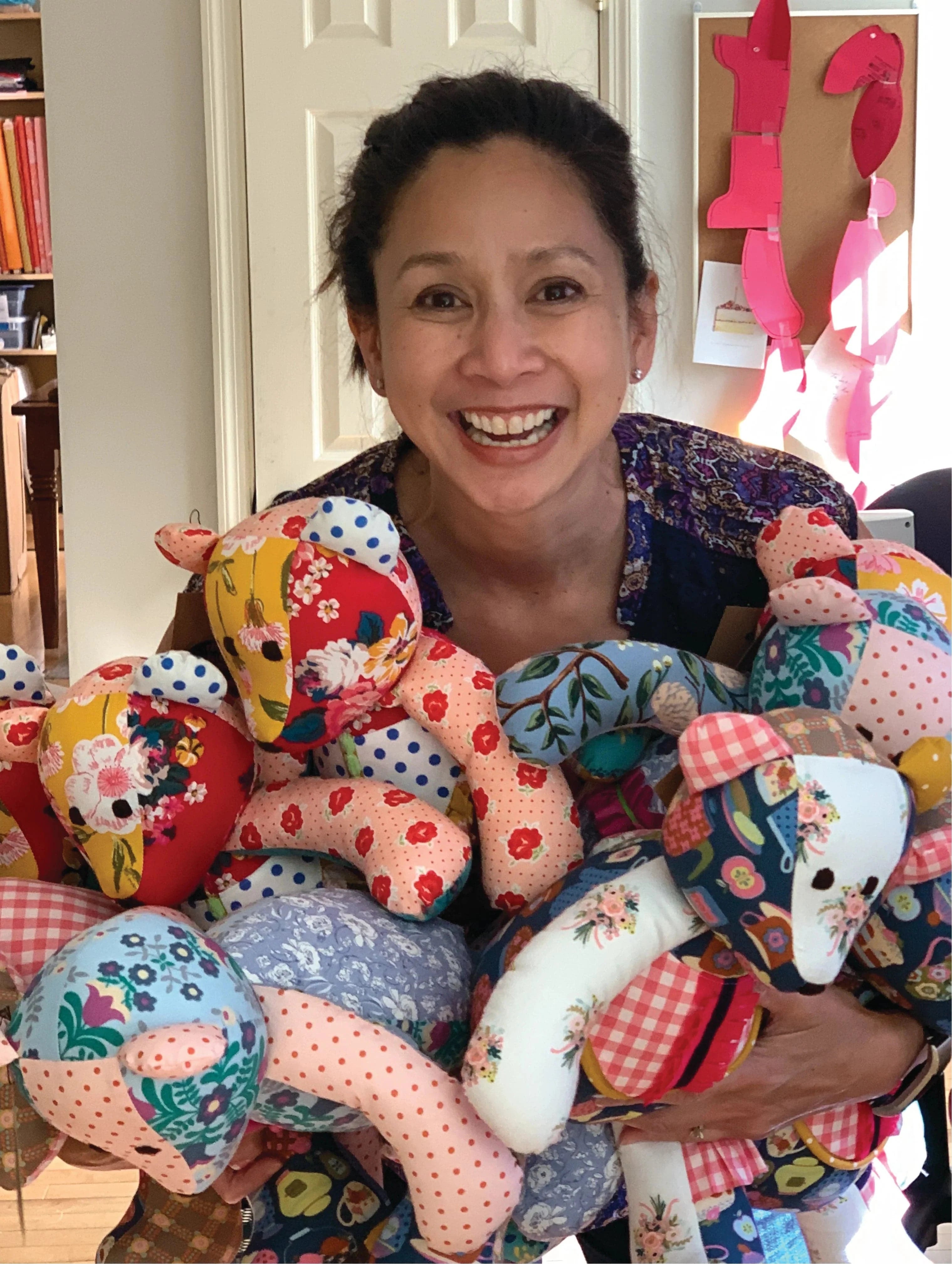 Woman holding handmade patchwork teddy bears