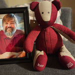 Red shirt bear made from shirts next to framed photo of Joey.