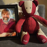 Red shirt bear made from shirts next to framed photo of Joey.