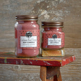 Two pink soy candles in mason jars.