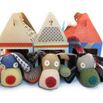 Three stuffed animal dogs with colorful houses.