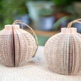 Paper book page ornaments with twine hangers.