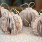 Paper book page ornaments with twine loops.