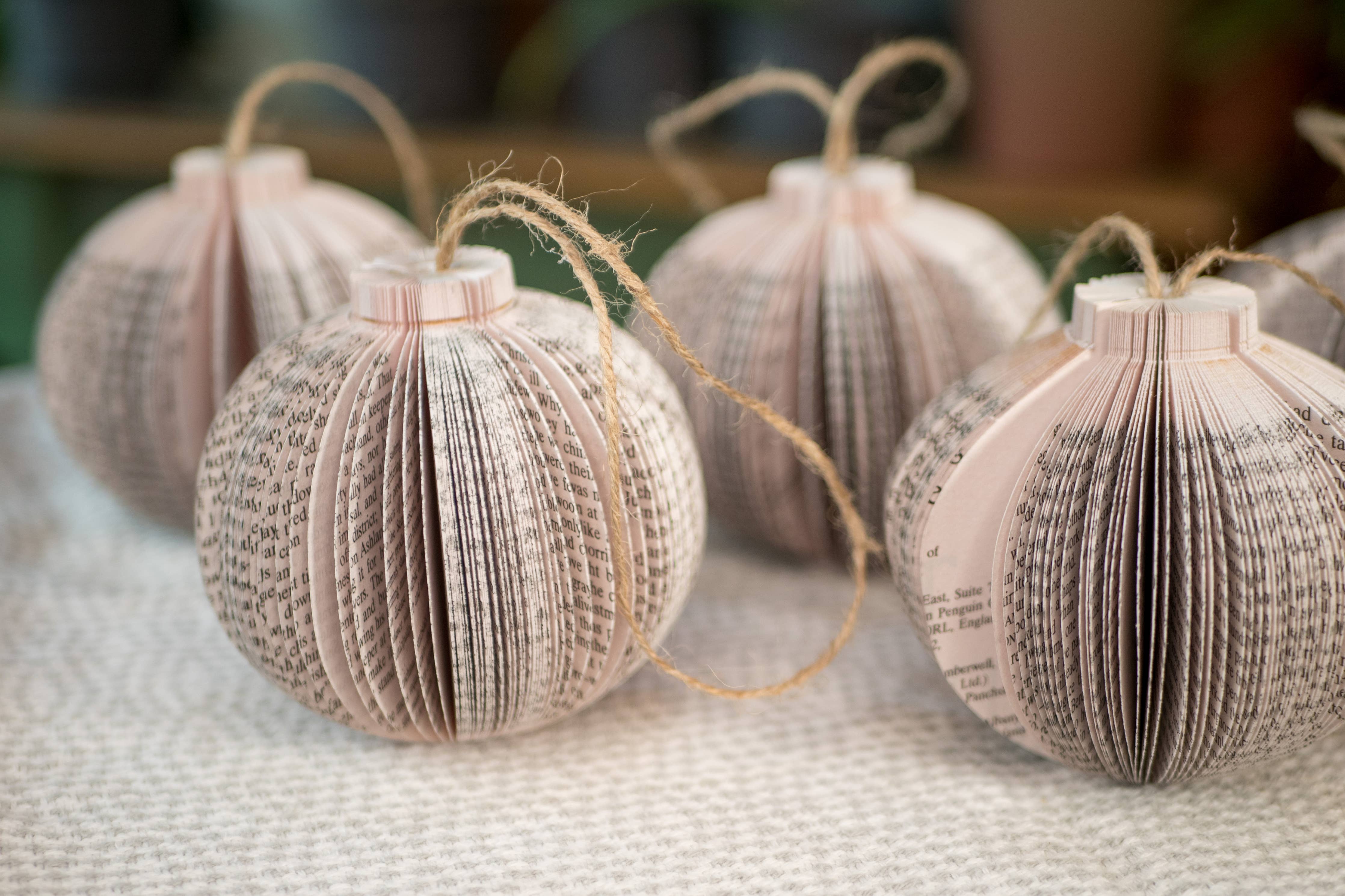 Paper book page ornaments with twine loops.