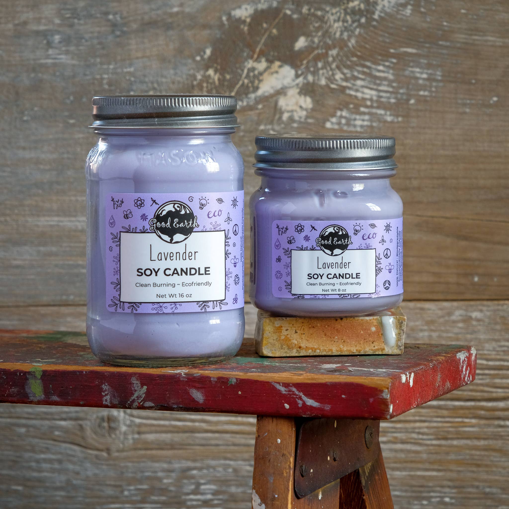 Two lavender soy candles in glass jars.