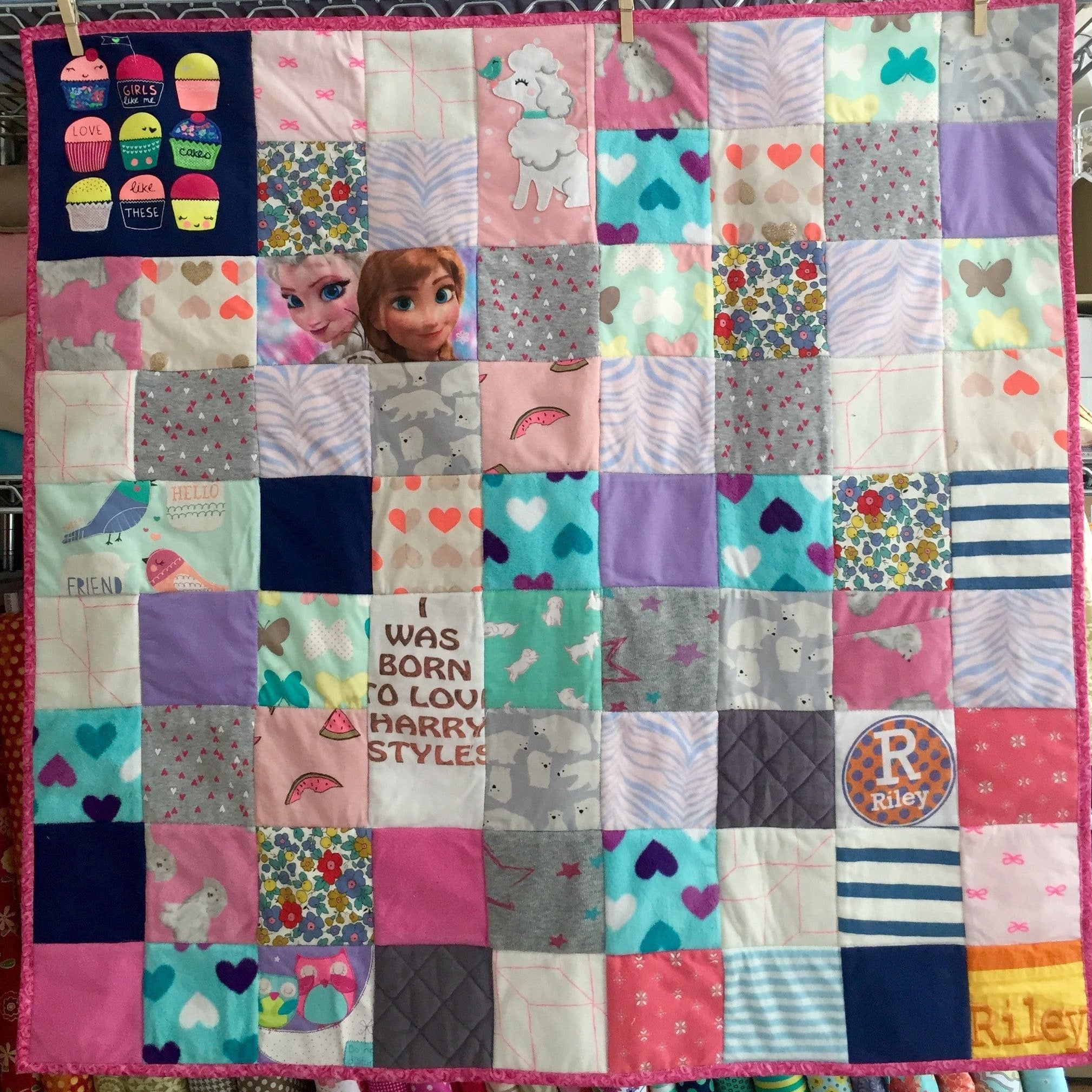 Girl's random patchwork quilt with cupcakes, Elsa, and Harry Styles fabrics.