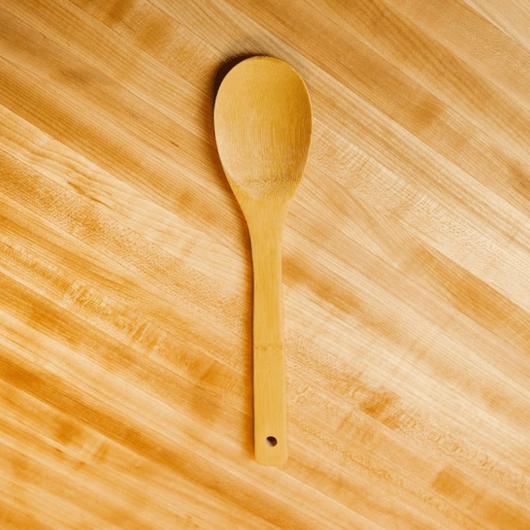 Wooden spoon on a wood surface.