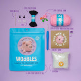 Crochet kit with yarn, hook, stuffing, and instructions.