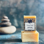 Orange fennel soap bar with a stack of stones.