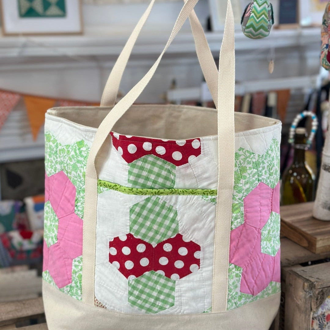 Quilted tote bag with floral design.