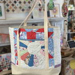Quilted tote bag with handles.