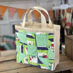 Canvas tote bag with a quilt panel.