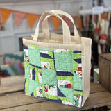 Canvas tote bag with a quilt panel.