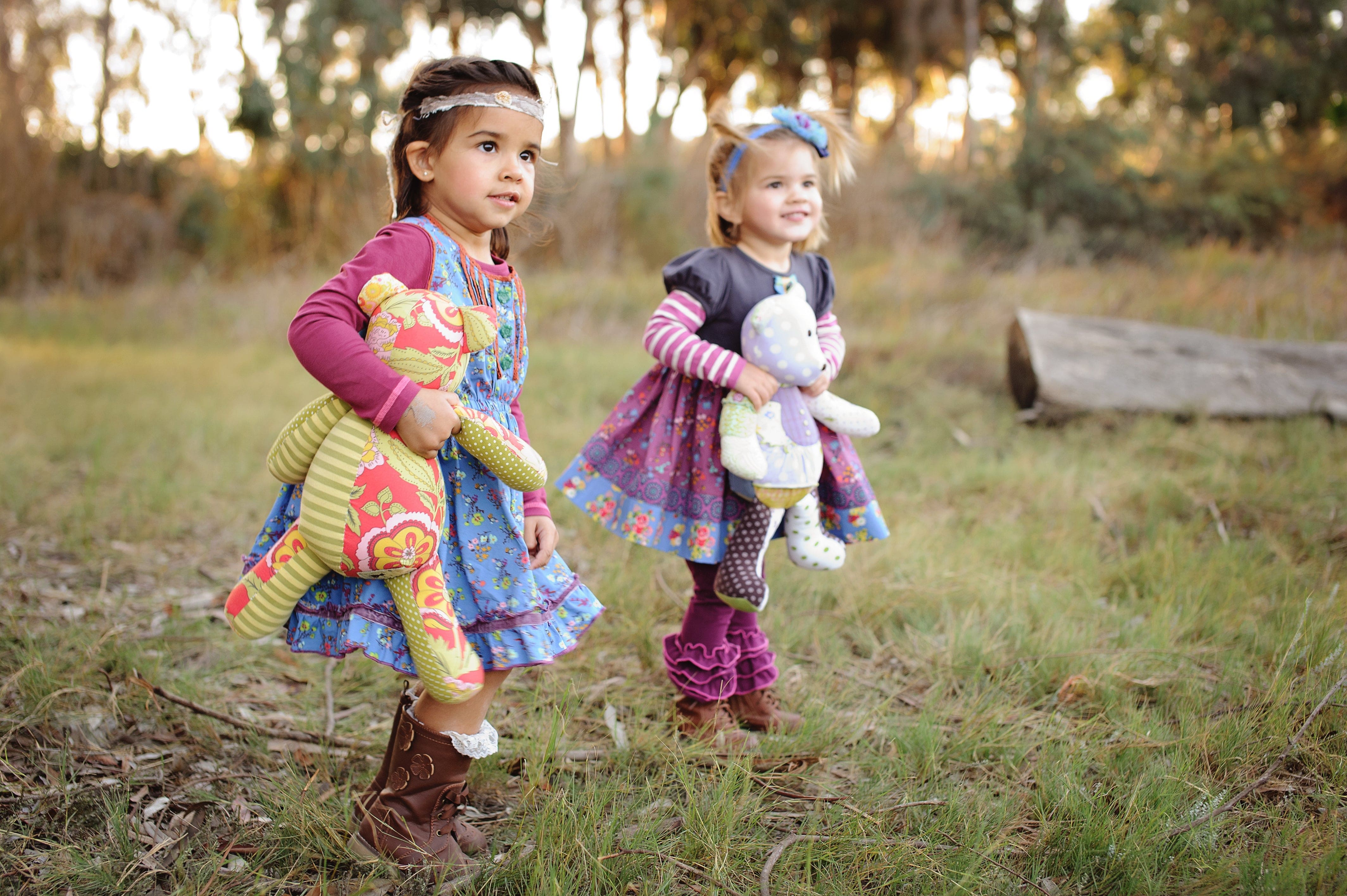 Two girls holding their memory bears made from favorite clothes
