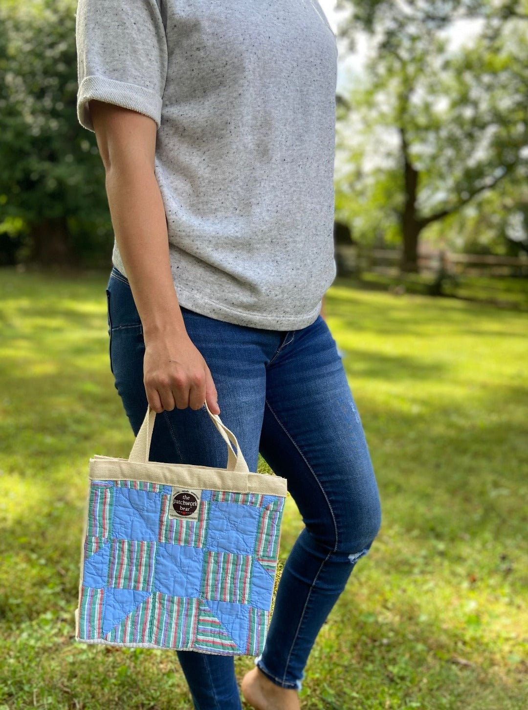 Woman holding blue patchwork handbag, Sep 12, 2023