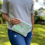 Woman holding quilted clutch, photo Sept 12, 2023