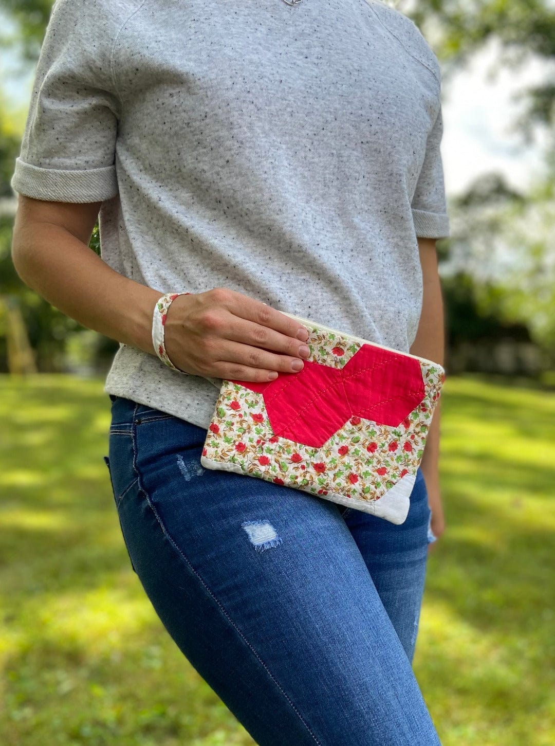 Woman holding red floral clutch, Sept 12, 2023 photo