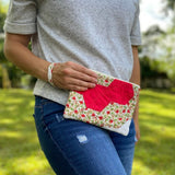 Woman holding red floral clutch, Sept 12, 2023 photo