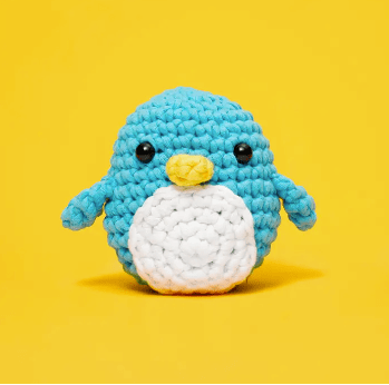 Crocheted blue penguin on yellow background - ScreenShot 2023-06-16