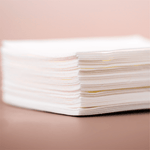 Stack of white paper napkins.