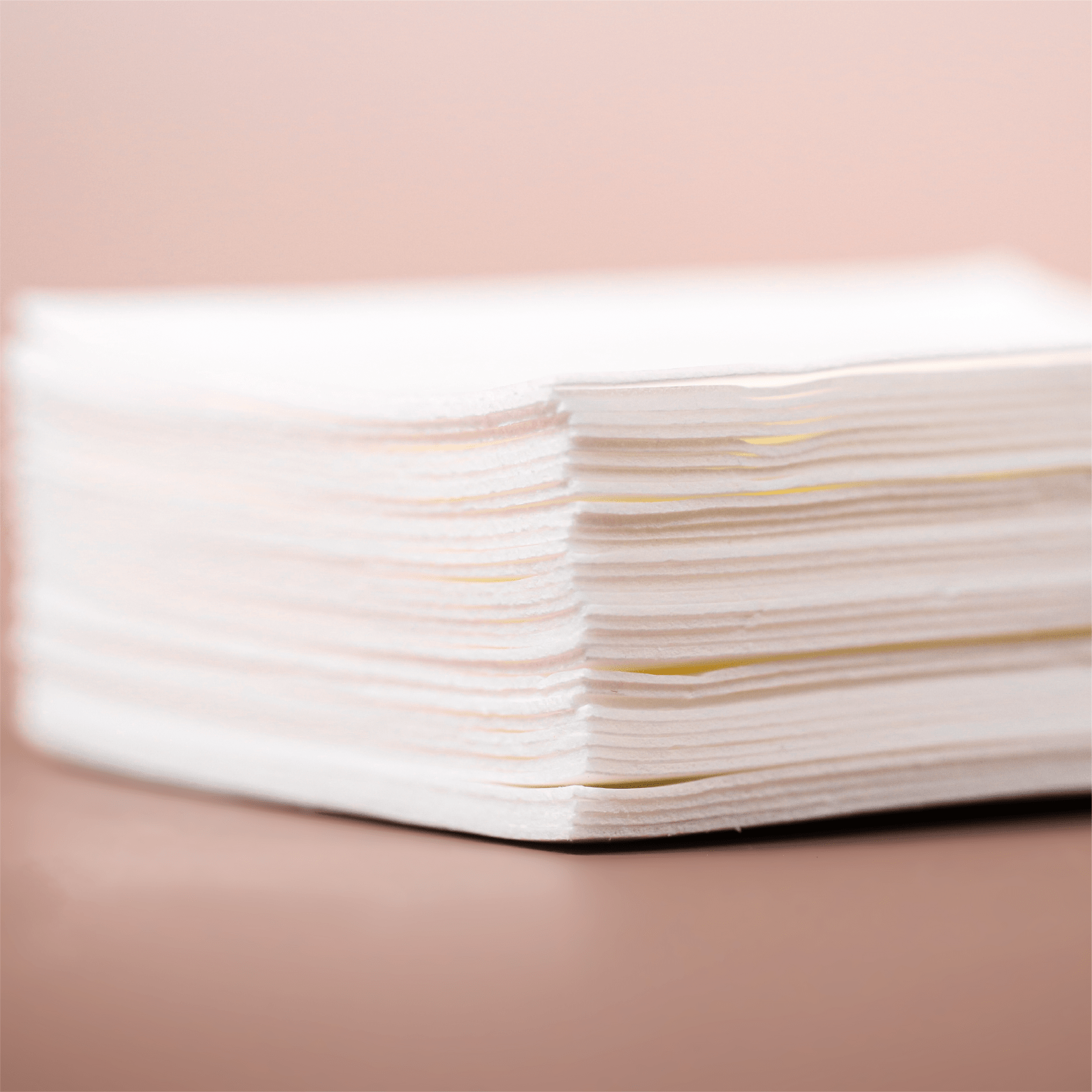 Stack of white paper napkins.