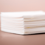 Stack of white paper napkins.