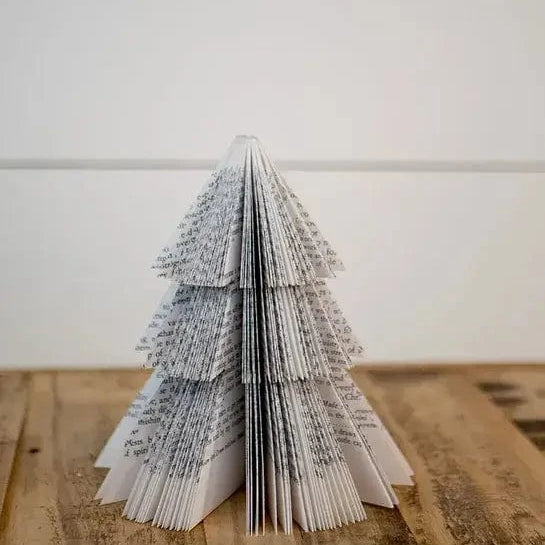 Paper Christmas tree on wooden surface.
