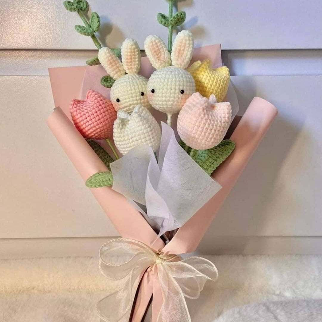 Crocheted bunny and tulip bouquet wrapped in pink paper.