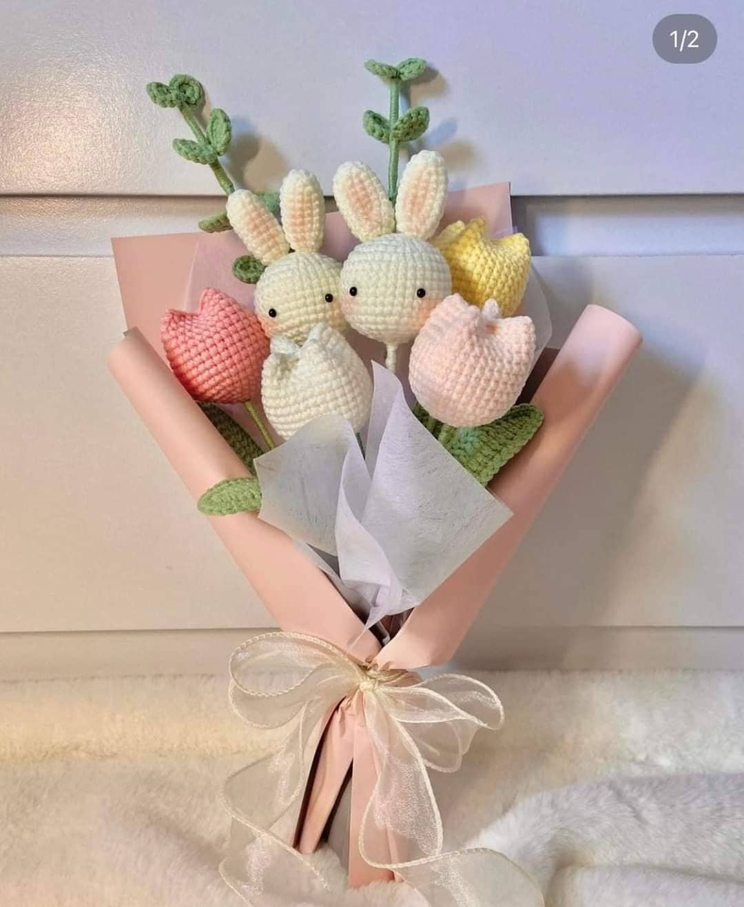 Crocheted bunny and tulip bouquet wrapped in pink paper.