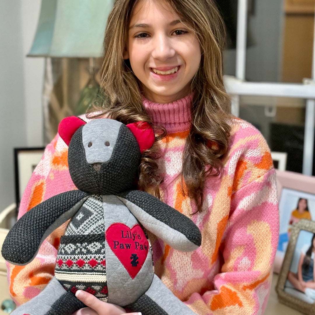 Girl holding Lily's Paw Paw bear