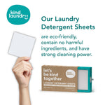 Hand holding laundry detergent sheet next to box.