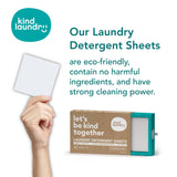 Hand holding laundry detergent sheet next to box.