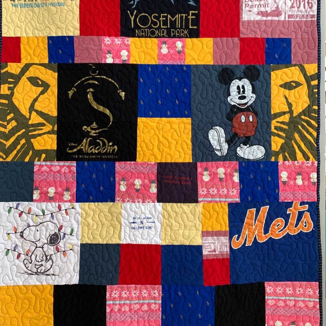 Disney quilt with Mickey Mouse, Aladdin, and Snoopy.