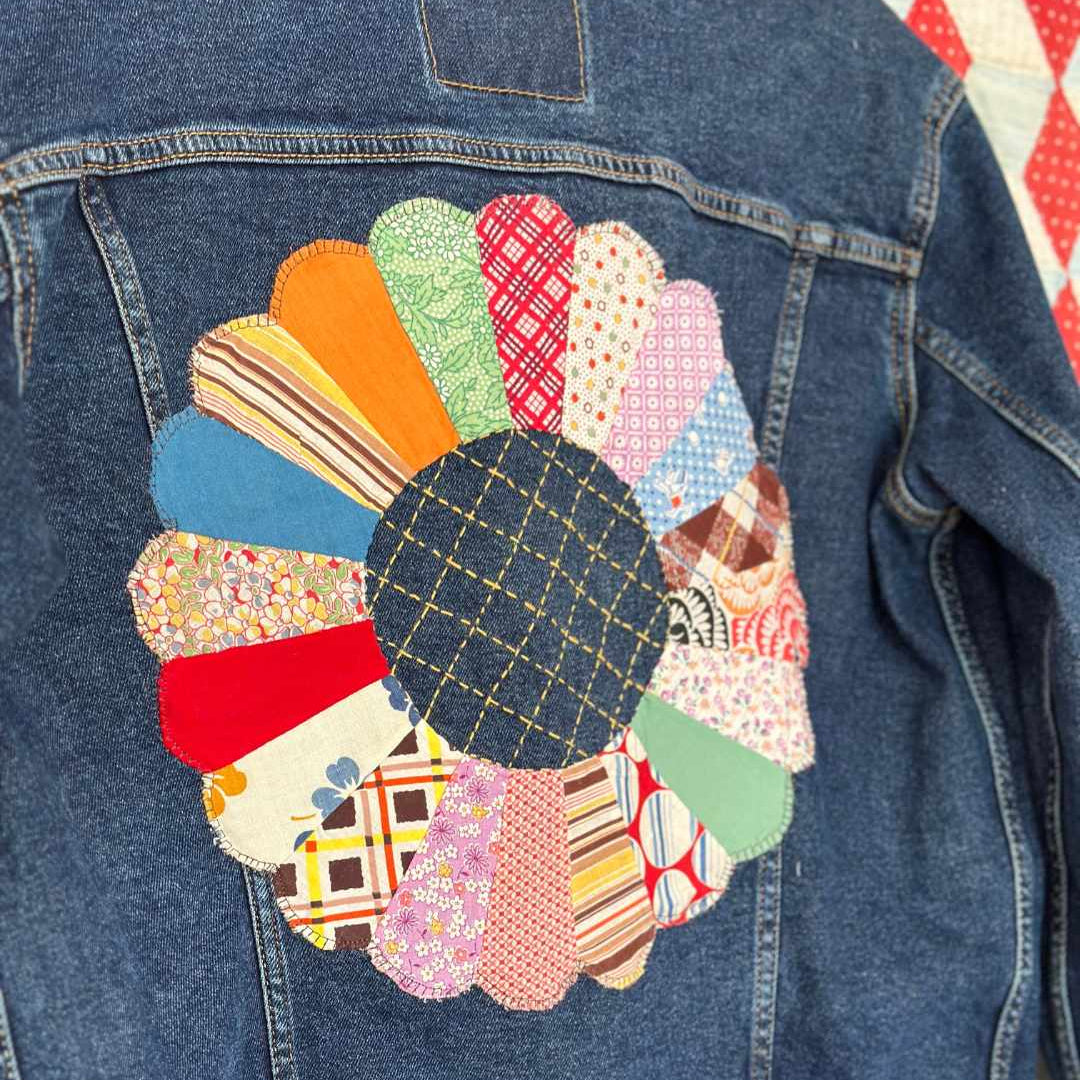 Denim jacket with vintage dresden plate block hand appliqued on back with sashiko stitching in center