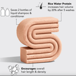 Pink, S-shaped hair care product bar with labels.