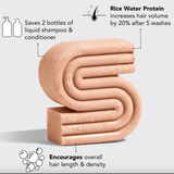 Pink, S-shaped hair care product bar with labels.