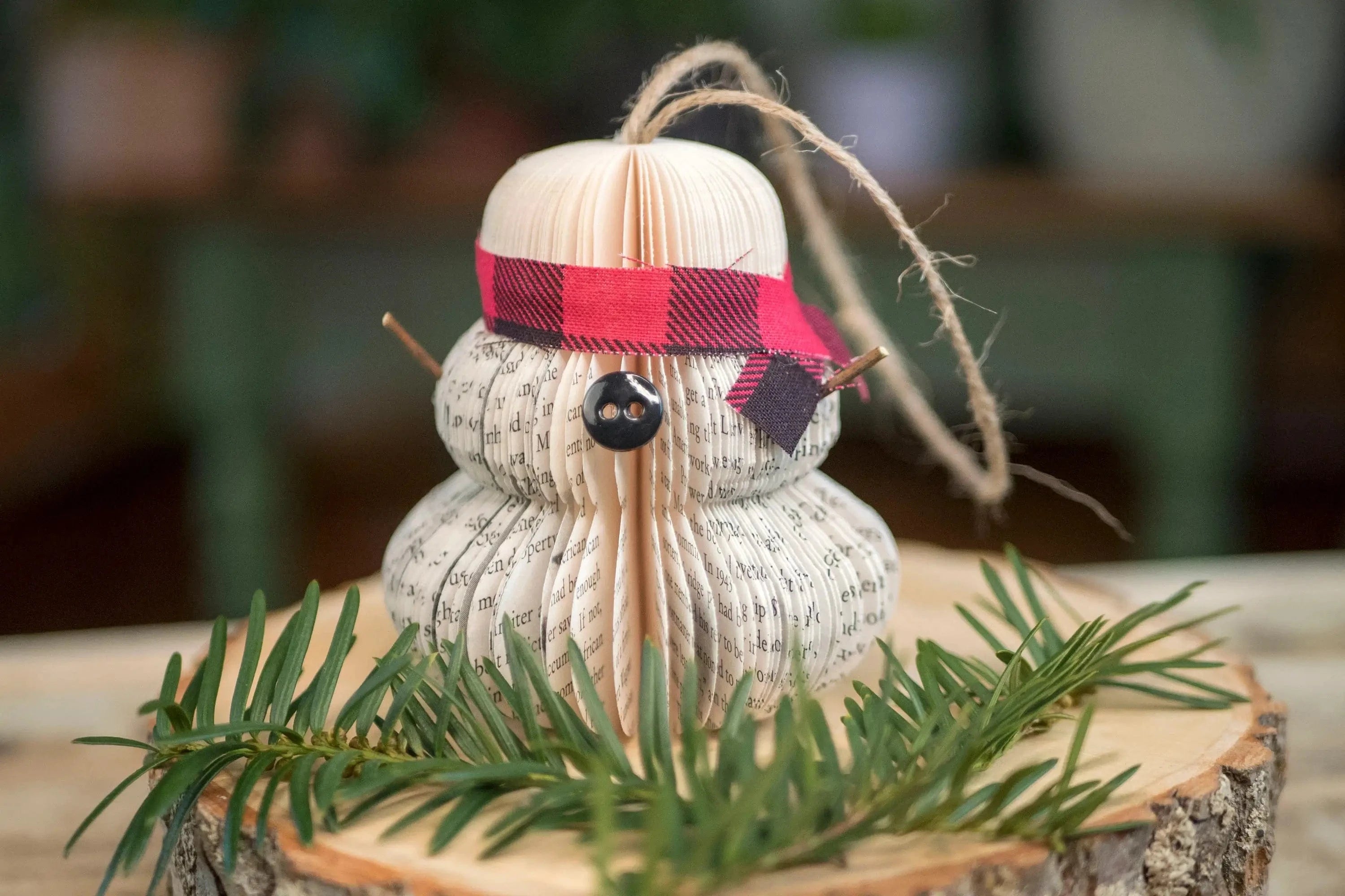 Snowman ornament with scarf and button.