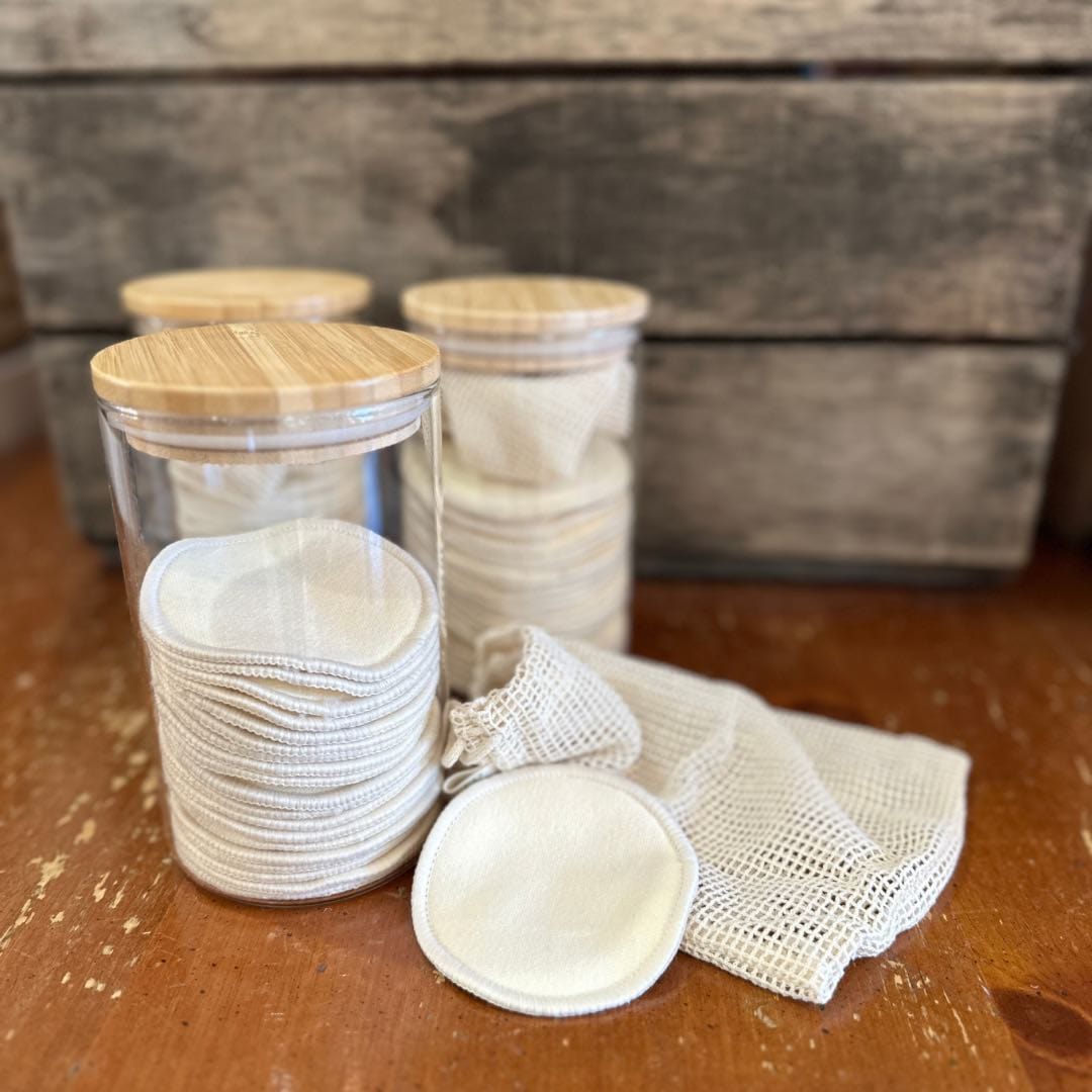 Hemp facial rounds in glass jars with wooden lids.