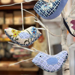 Memory birds hanging on a decorative branch