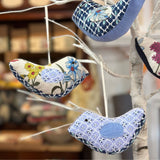 Memory birds hanging on a decorative branch