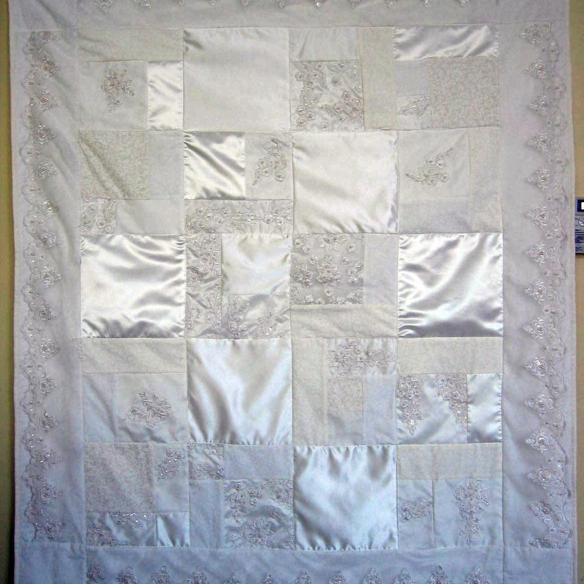 Lee's wedding quilt with white satin and lace details