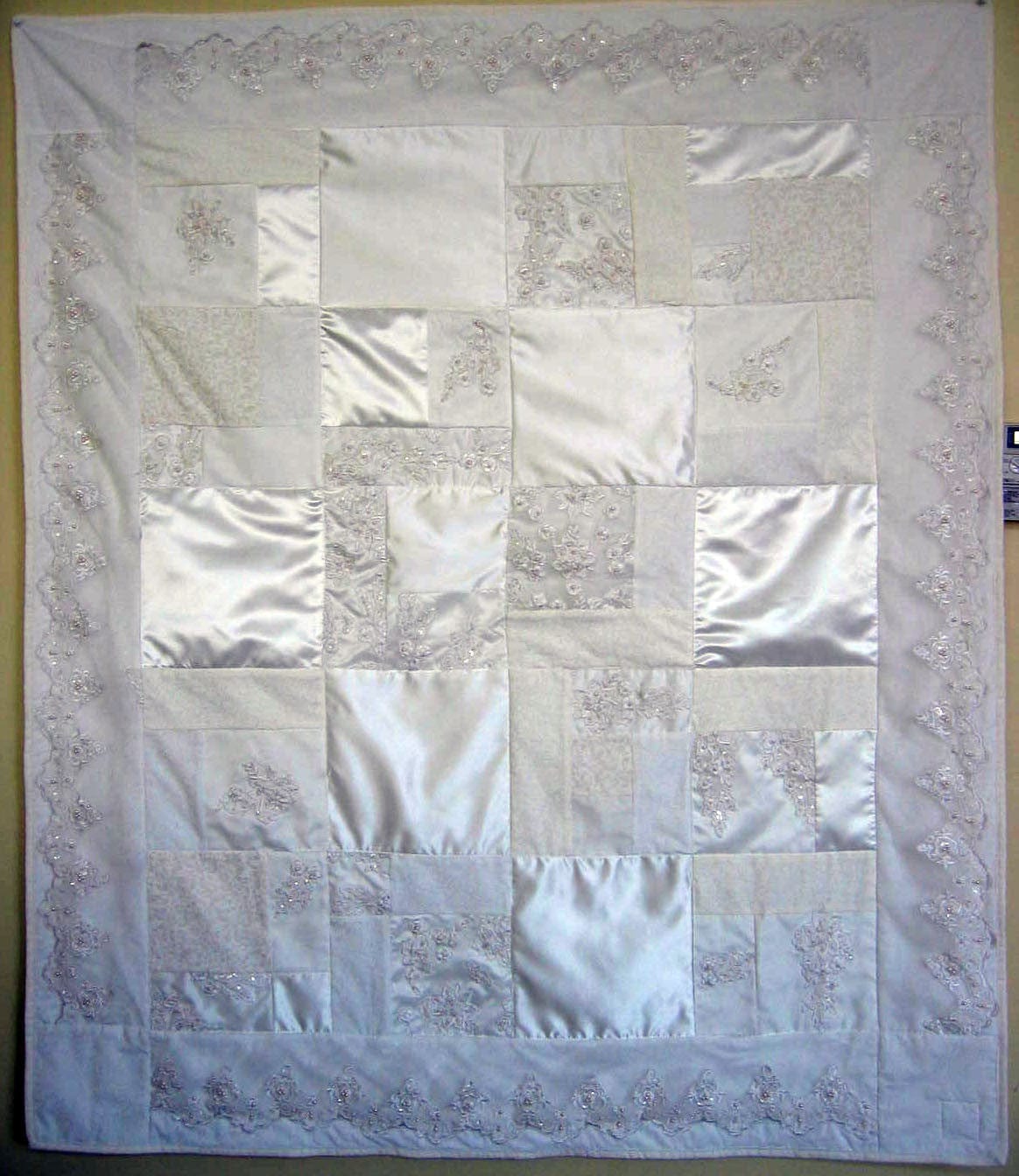 Lee's wedding quilt with white satin and lace details