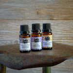 Three essential oil bottles on a shovel.