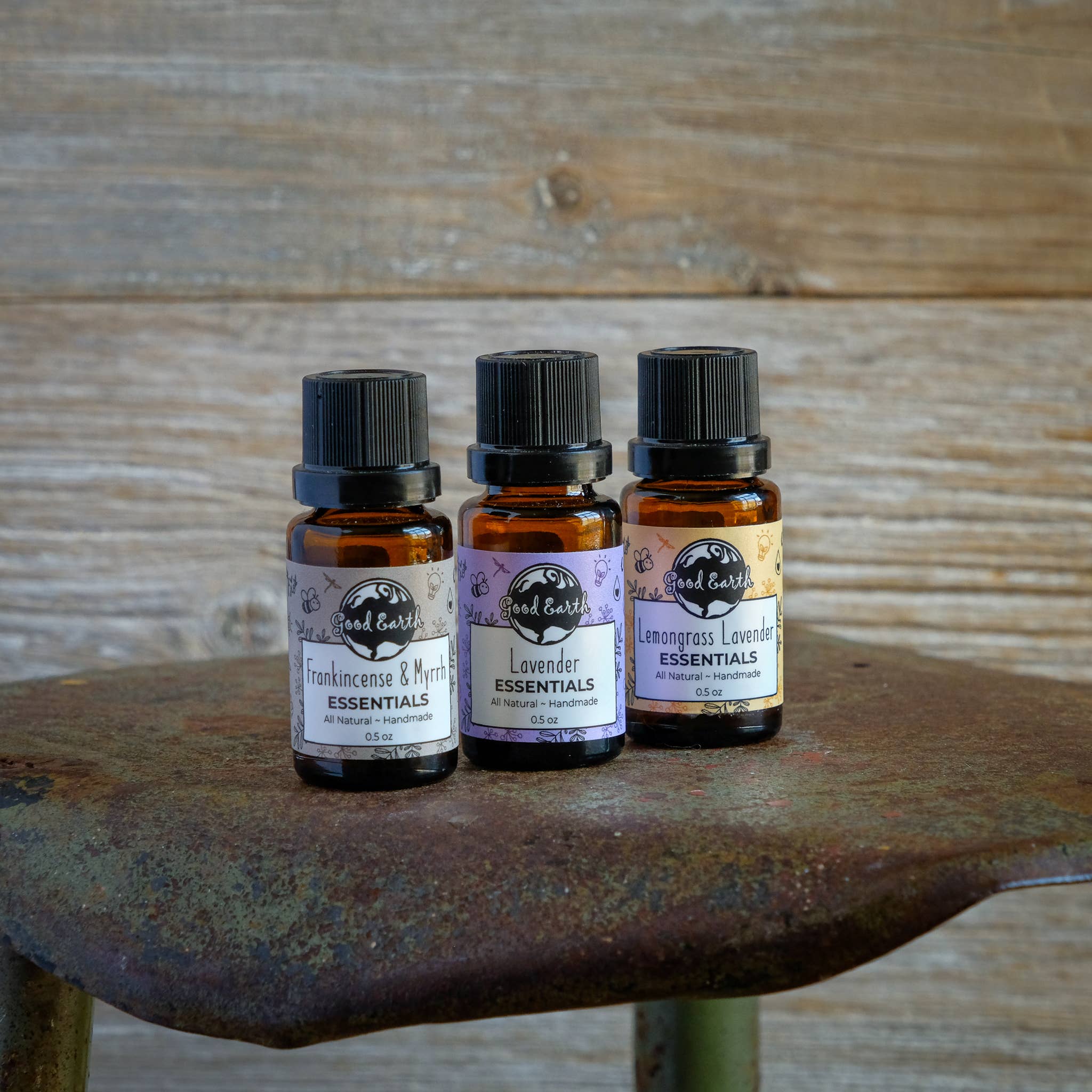 Three essential oil bottles on a shovel.