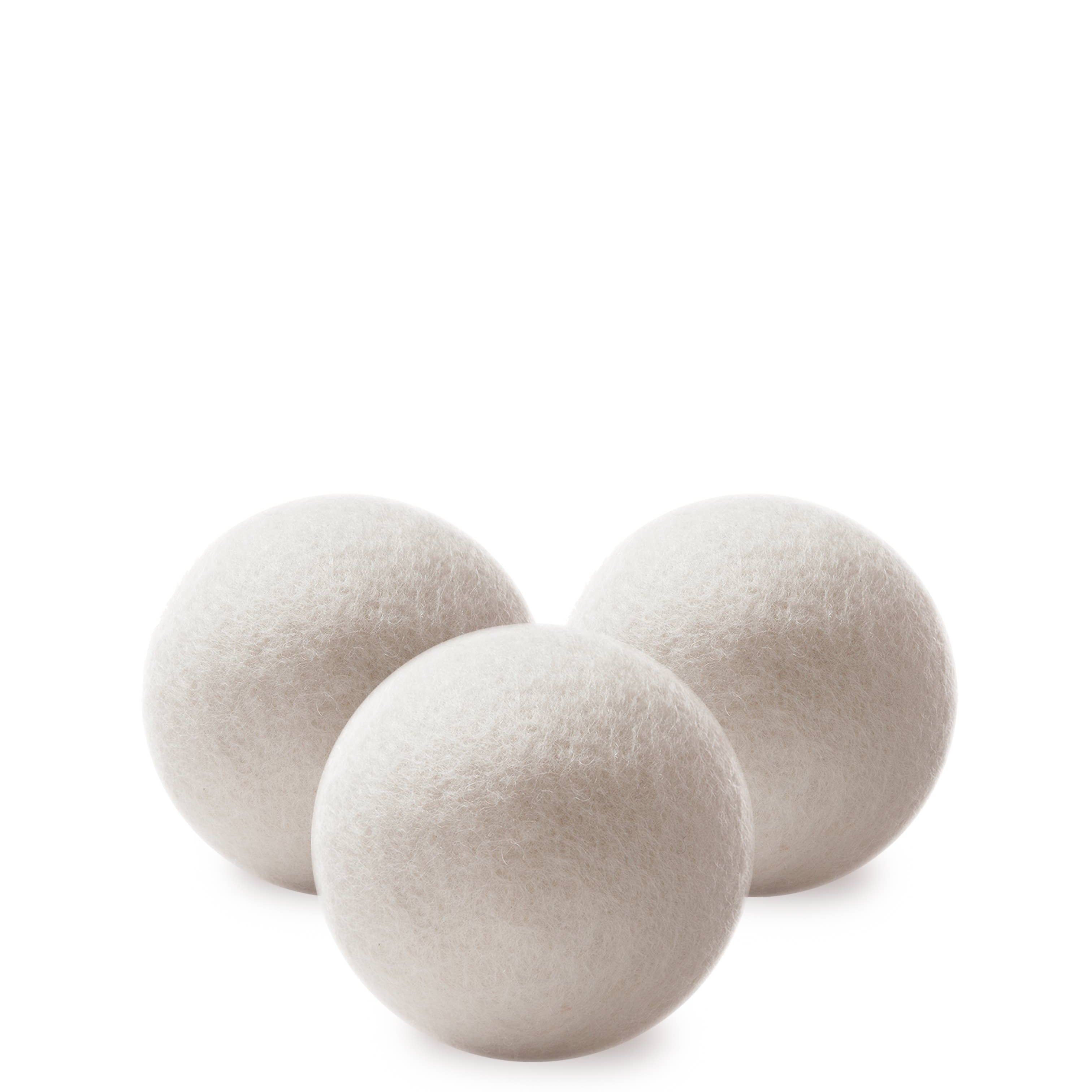 Three white wool dryer balls.