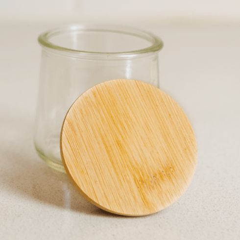 Glass jar with wooden lid.