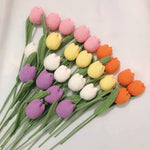 Crocheted tulips in various colors.